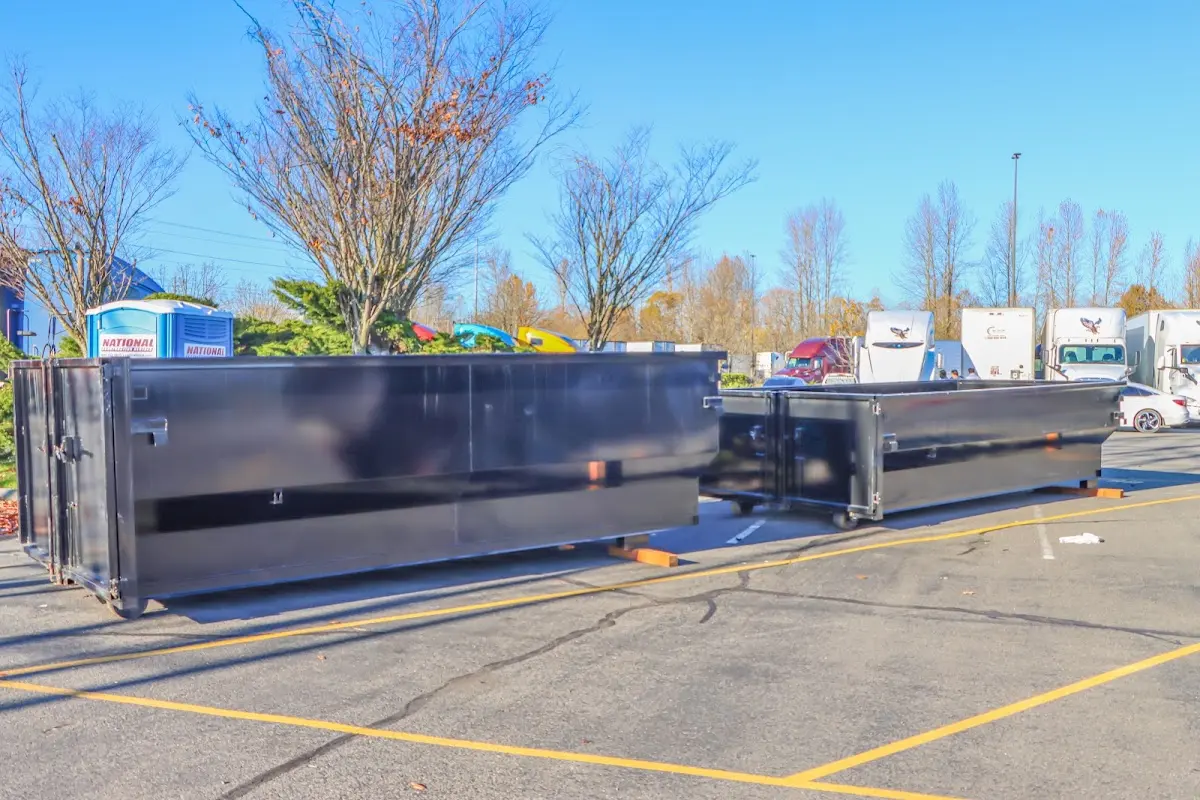 Professional dumpster rental service with roll-off container on residential driveway in Maple Shade